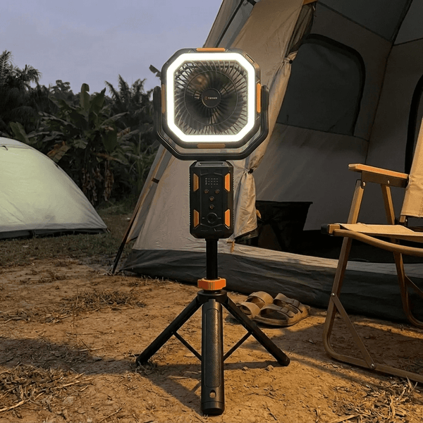 TAHAN Typhoon Pro fan and light glowing at a campsite at dusk in front of a tent