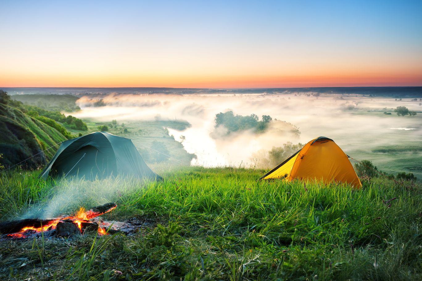 tent-camping-on-hill-over-misty-river-PQB6XP3 - TAHAN Worldwide