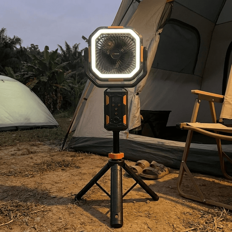 TAHAN Typhoon Pro fan and light glowing at a campsite at dusk in front of a tent